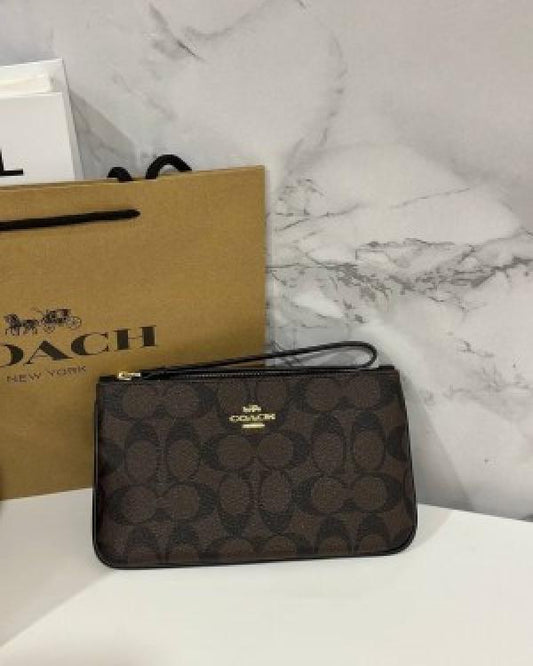 Coach Corner Zip Wristlet In Signature Canvas With Brown 101